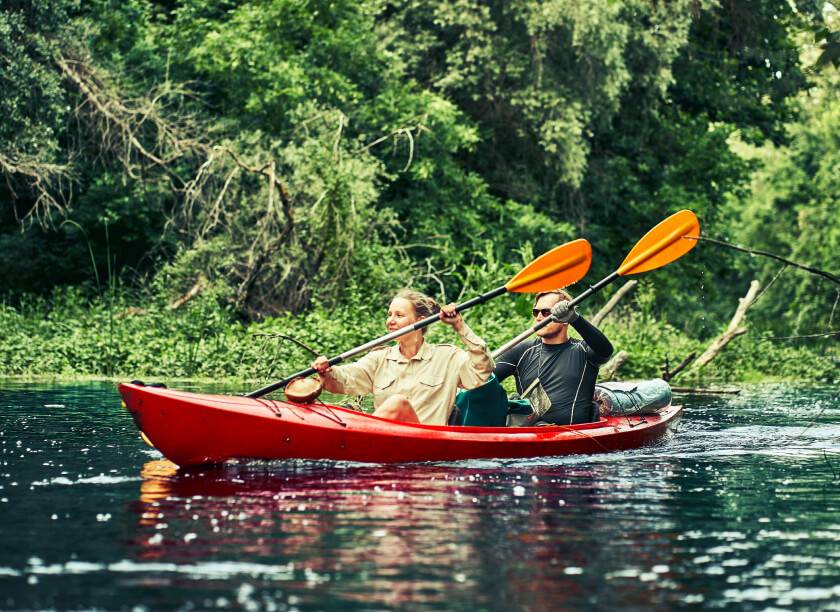 A couple kayaking together on an active adventure