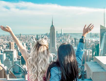 two friends admiring the view of new york city from above
