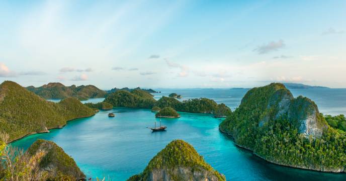 View of a traditional sailing boat cruising around the many inlets and islands of Indonesia