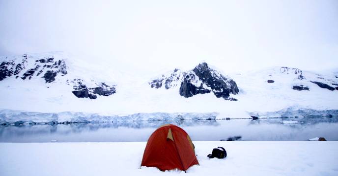 A tent set up on a snowy landscape