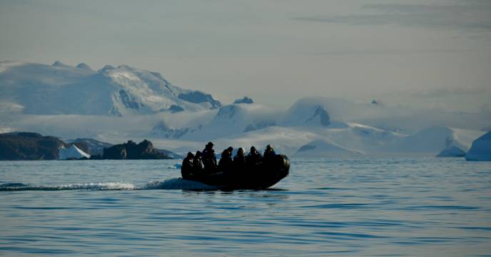 A group of people on a zodiac boat