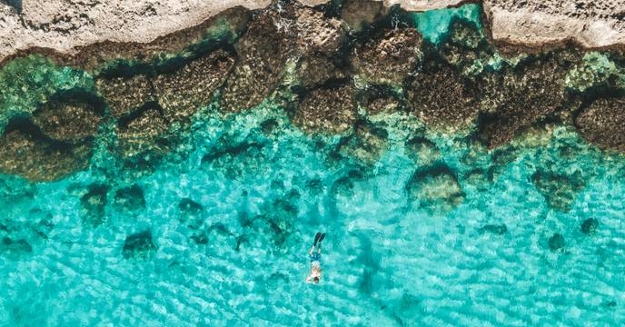 Person relaxing in azure waters