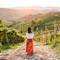 A woman walking amongst wineyards
