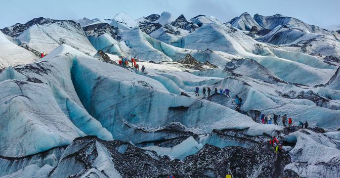 People hiking snowy landscapes in Iceland