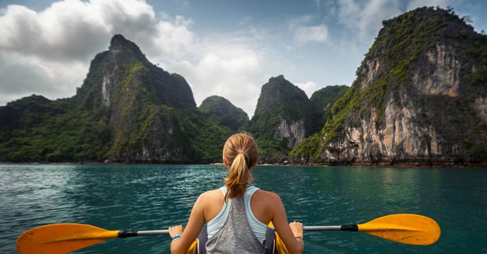Woman kayaking in Halong Bay