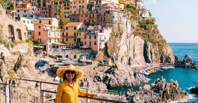 Woman enjoying the view of the village of Manarola