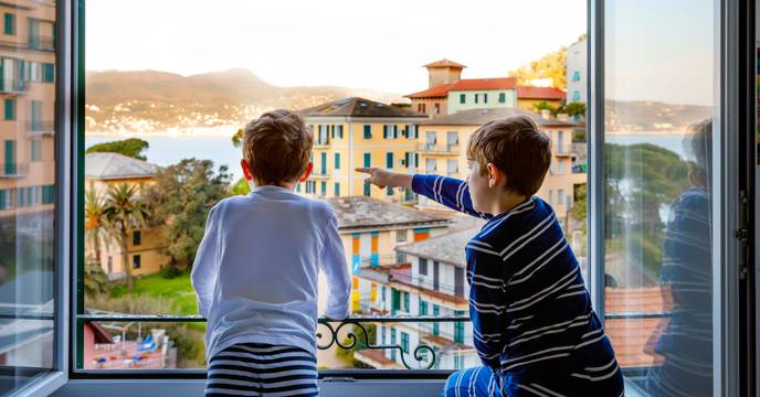 Kids enjoying the view of a colorful village in Italy