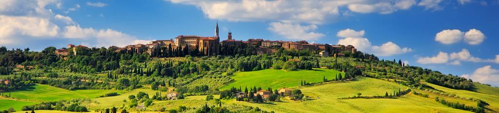 A Tuscan village gracing verdant rolling hills