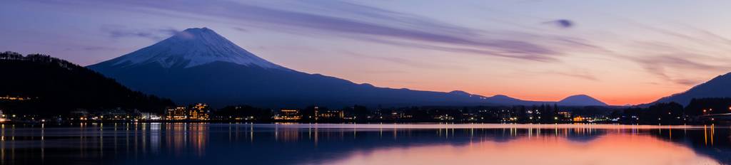 View of a lake and the towering Mount Fuji