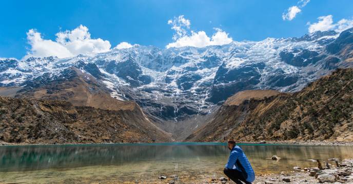 Person enjoying the view of a lake and mountains