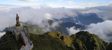 Panoramic view of mountains and a statue
