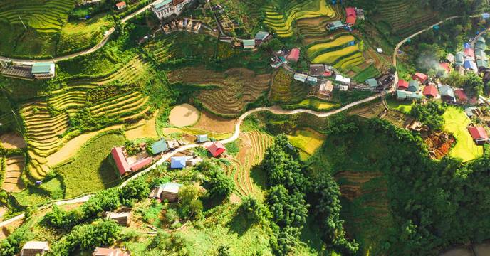Birds-eye view of terraced rice fields and colorful houses