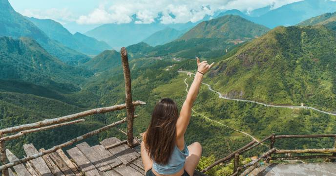 A girl enjoying the panoramic view of mountains in Sapa