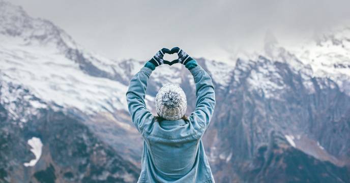 women in front of Canadian mountains in winter