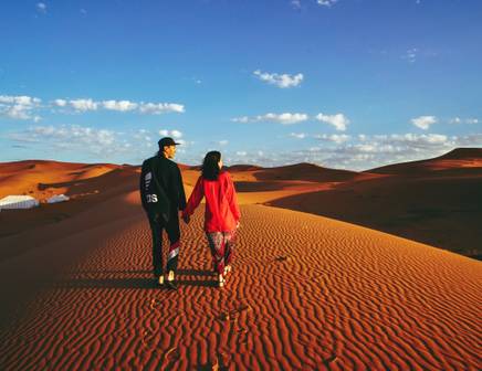 Young couple walking in the Moroccan desert
