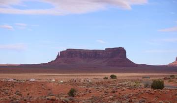 Monument Valley under a clear, blue sky.
