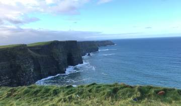 Cliffs of Moher with the sea below and clear skies above.