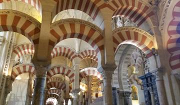 Interior of the Mosque-Cathedral of Córdoba with red and white arches.