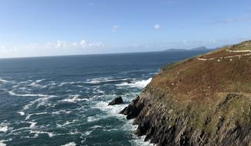Coastal cliffs with waves crashing against them.