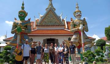 Group posing in front of a temple with guardian statues.