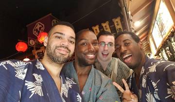 Four friends in traditional attire taking a selfie.