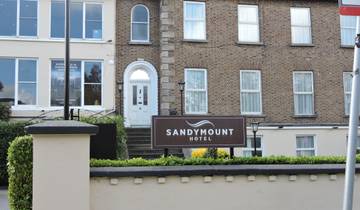 Sandymount Hotel sign in front of a brick building.