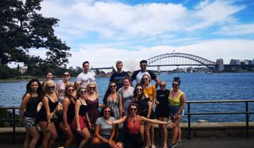 A group of people posing with the Sydney Harbour Bridge in the background.