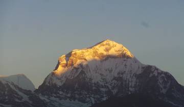 Golden hue on a snow-capped mountain peak.