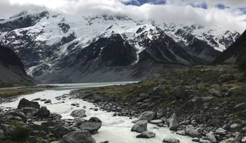 Snow-capped mountains with a river flowing below.