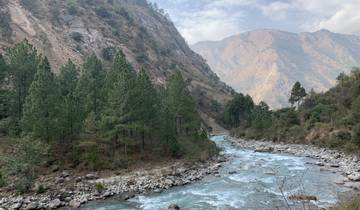 River flowing through a valley surrounded by mountainous terrain.