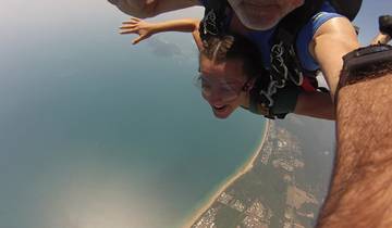 Tandem skydiving over a coastal area