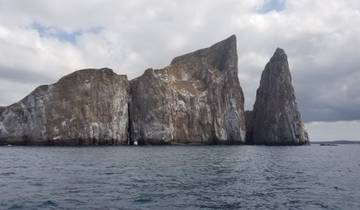 Dramatic rock formations rising from the ocean.