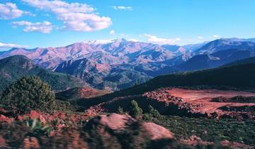 Panoramic view of mountain ranges under blue sky.