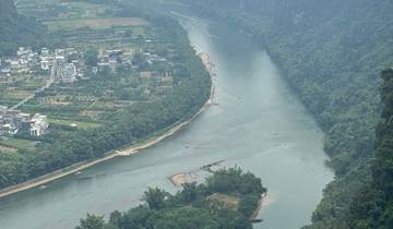 A river winding through lush green landscapes and mountains.