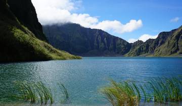Scenic view of a lake surrounded by mountains.