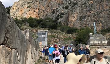 Tourists walking on ancient stone steps outside.