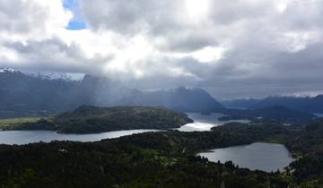 Scenic aerial view of lakes and mountains with dramatic clouds.