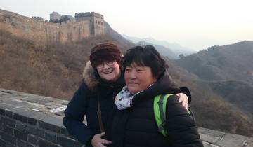 Two people posing on the Great Wall of China.