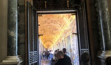 Interior view of a crowded, ornately decorated corridor.