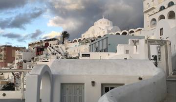 White buildings with domes in an island setting.