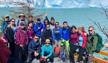 Group of people with glacier and blue water in the background.