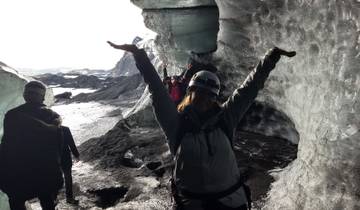 Group exploring inside a glacial ice cave.