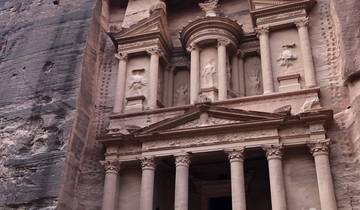The famous Treasury at Petra with tourists in the foreground.