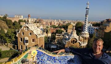 View of Park Güell with unique architectural features and a person enjoying the view.