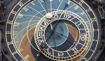 Close-up of an astronomical clock face with intricate design.