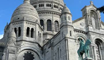 A detailed close-up of the Sacré-Cœur Basilica against a blue sky.