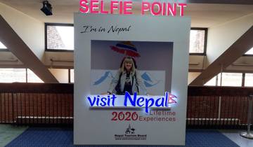 Visitor inside a selfie booth promoting Nepal 2020.