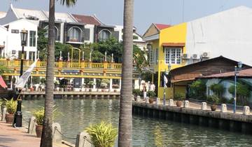 Colorful canal-side architecture with a bridge.