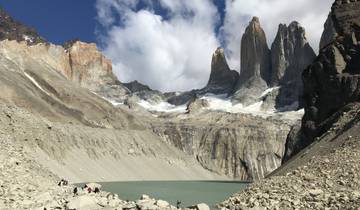 Towering peaks surrounding a glacial lake.