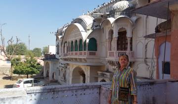 Person in front of an ornate traditional building.